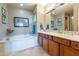 Elegant bathroom with a soaking tub, dual sinks, and stylish vanity lighting at 16336 E Ridgeline Dr, Fountain Hills, AZ 85268