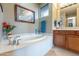 Bathroom with a soaking tub, and cherry wood cabinets, offering a luxurious retreat at 16336 E Ridgeline Dr, Fountain Hills, AZ 85268