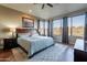 Inviting bedroom featuring large windows, hardwood floors, ceiling fan, and a cozy rug at 16336 E Ridgeline Dr, Fountain Hills, AZ 85268