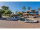 Water fountain in a brick courtyard with commercial buildings, trees and clear blue sky in Fountain Hills, Arizona at 16336 E Ridgeline Dr, Fountain Hills, AZ 85268