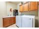 Laundry room featuring wooden cabinets, sink, counterspace, and modern washer and dryer at 16336 E Ridgeline Dr, Fountain Hills, AZ 85268