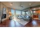 Spacious living room featuring hardwood floors, a stone fireplace, and large windows with views at 16336 E Ridgeline Dr, Fountain Hills, AZ 85268