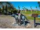 Statue of a boy leaning on a dog along a stone pathway with a lake view in Fountain Hills, Arizona at 16336 E Ridgeline Dr, Fountain Hills, AZ 85268