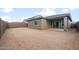 View of the home's backyard with a covered patio and privacy wall at 17758 W Getty Dr, Goodyear, AZ 85338