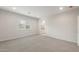 Bright bedroom with neutral carpet, window, and ensuite bathroom entrance at 17758 W Getty Dr, Goodyear, AZ 85338