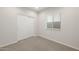 Neutral bedroom showcasing carpeted flooring, a closet, and a window at 17758 W Getty Dr, Goodyear, AZ 85338