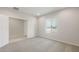 Neutral bedroom featuring carpet, white walls, a window providing natural light, and a walk-in closet with a six-panel door at 17758 W Getty Dr, Goodyear, AZ 85338