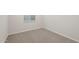Cozy bedroom with neutral carpet, a window, and light-colored walls at 17758 W Getty Dr, Goodyear, AZ 85338