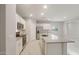 Modern kitchen with white cabinets, stainless steel appliances, gray countertops, a center island, and an open layout at 17758 W Getty Dr, Goodyear, AZ 85338