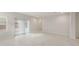 Bright, open-concept living room featuring tile flooring, white walls, and sliding doors leading to the backyard at 17758 W Getty Dr, Goodyear, AZ 85338