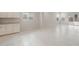 Spacious and bright living room with tile flooring, white cabinets, and large windows providing natural light at 17758 W Getty Dr, Goodyear, AZ 85338