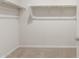 Walk-in closet with carpeted flooring, ample shelving, and hanging space at 17758 W Getty Dr, Goodyear, AZ 85338