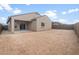 Exterior view of the home's backyard with a covered patio and fencing at 17764 W Getty Dr, Goodyear, AZ 85338