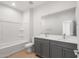 Bathroom showcasing a double sink vanity and a shower-tub combination at 17764 W Getty Dr, Goodyear, AZ 85338