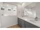 Bathroom featuring a double sink vanity with a large mirror and a glass-enclosed shower at 17764 W Getty Dr, Goodyear, AZ 85338