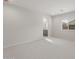 Bright bedroom featuring neutral carpet and a doorway to the en suite bathroom at 17764 W Getty Dr, Goodyear, AZ 85338