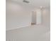 Neutral bedroom with light carpet, white walls, and a door to the walk-in closet at 17764 W Getty Dr, Goodyear, AZ 85338