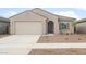 Single-story home featuring a neutral color palette, tiled roof, and attached two-car garage at 17764 W Getty Dr, Goodyear, AZ 85338