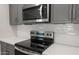 Up close picture of the kitchen featuring stainless steel appliances and tiled backsplash at 17764 W Getty Dr, Goodyear, AZ 85338