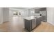 Open-concept kitchen featuring gray cabinetry, stainless steel appliances, and a center island at 17764 W Getty Dr, Goodyear, AZ 85338