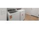 Laundry room featuring a new washer and dryer set and durable wood-look flooring at 17764 W Getty Dr, Goodyear, AZ 85338
