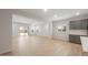 Bright living room with modern wood-look tile floors and gray kitchen cabinets at 17764 W Getty Dr, Goodyear, AZ 85338
