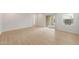 Spacious living room with wood-look flooring and a sliding glass door that leads to the patio at 17764 W Getty Dr, Goodyear, AZ 85338