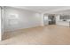 Open living space with wood-look flooring flowing into the kitchen with gray cabinets at 17764 W Getty Dr, Goodyear, AZ 85338