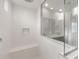 A spacious glass shower with white subway tile, a bench, and a rainfall shower head at 17764 W Getty Dr, Goodyear, AZ 85338