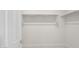 A walk-in closet with white walls, shelving, and hanging racks for ample storage space at 17764 W Getty Dr, Goodyear, AZ 85338