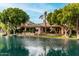 Back exterior view of property from the lake showing covered patio, grill, and meticulously landscaped surroundings at 1833 W Mead Pl, Chandler, AZ 85248