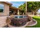 Backyard with a rock waterfall flowing into a pool, creating a relaxing oasis at 1833 W Mead Pl, Chandler, AZ 85248