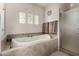 Beautiful bathroom featuring a soaking tub, glass enclosed shower, and neutral finishes at 1833 W Mead Pl, Chandler, AZ 85248