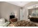 Cozy bedroom featuring a mirrored closet, dresser, and comfortable sitting area at 1833 W Mead Pl, Chandler, AZ 85248