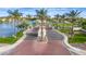 The well-manicured community entrance with palm trees, and a scenic lake view, invites residents and guests at 1833 W Mead Pl, Chandler, AZ 85248