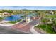 Aerial view of a gated community entrance amidst lush landscaping, providing secure access to luxurious lakeside living at 1833 W Mead Pl, Chandler, AZ 85248
