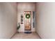 Cozy front entrance with a decorative wreath on the wood door, surrounded by neutral stucco walls at 1833 W Mead Pl, Chandler, AZ 85248