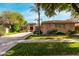 Stunning single-story home featuring a well-manicured lawn, mature trees, and a spacious three-car garage at 1833 W Mead Pl, Chandler, AZ 85248