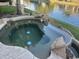 Relaxing hot tub with rock features and waterfront views for enjoying peaceful moments by the water at 1833 W Mead Pl, Chandler, AZ 85248
