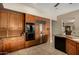 Gourmet kitchen displays wooden cabinets and stainless appliances, including a built-in refrigerator and double oven at 1833 W Mead Pl, Chandler, AZ 85248