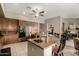 Modern kitchen showcasing a granite island with seating, built-in stainless appliances, and tile flooring at 1833 W Mead Pl, Chandler, AZ 85248