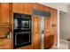 Gourmet kitchen displays wooden cabinets and stainless appliances, including a built-in refrigerator and oven at 1833 W Mead Pl, Chandler, AZ 85248