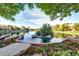 A serene lake view featuring vibrant flowers and stonework creating a calming waterfront experience at 1833 W Mead Pl, Chandler, AZ 85248