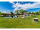 Picturesque lake view with a waterfall feature, verdant grass, and mature trees offering a tranquil environment at 1833 W Mead Pl, Chandler, AZ 85248