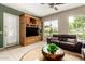 Spacious living room featuring lake view, sleek furniture, and built-in entertainment center at 1833 W Mead Pl, Chandler, AZ 85248