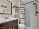 Modern bathroom with sleek fixtures and a black and white shower curtain at 18820 N 34Th Ln # 1, Phoenix, AZ 85027