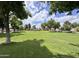 Lush community park offers an open grassy area and scattered trees for a serene outdoor setting at 18820 N 34Th Ln # 1, Phoenix, AZ 85027