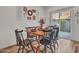 Dining room with wood table, chairs, wood floors and sliding glass doors to outdoor area at 18820 N 34Th Ln # 1, Phoenix, AZ 85027
