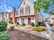 Charming two-story townhome featuring a brick chimney, red shutters, and a well-manicured front yard at 18820 N 34Th Ln # 1, Phoenix, AZ 85027