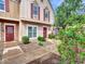 Inviting townhome exterior with red front doors, cozy windows, and lovely greenery at 18820 N 34Th Ln # 1, Phoenix, AZ 85027
